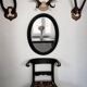 Antique oval mirror in patinated black wood