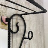 Wall-mounted coat rack with its mirror.