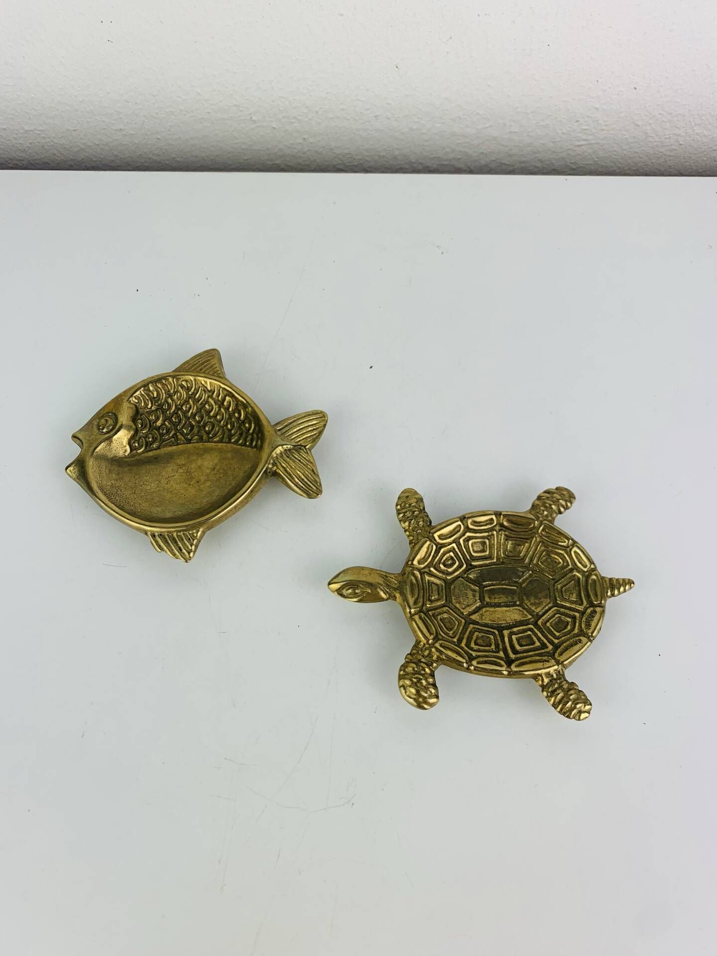 Pair of animal trinket trays in brass, fish and turtle.