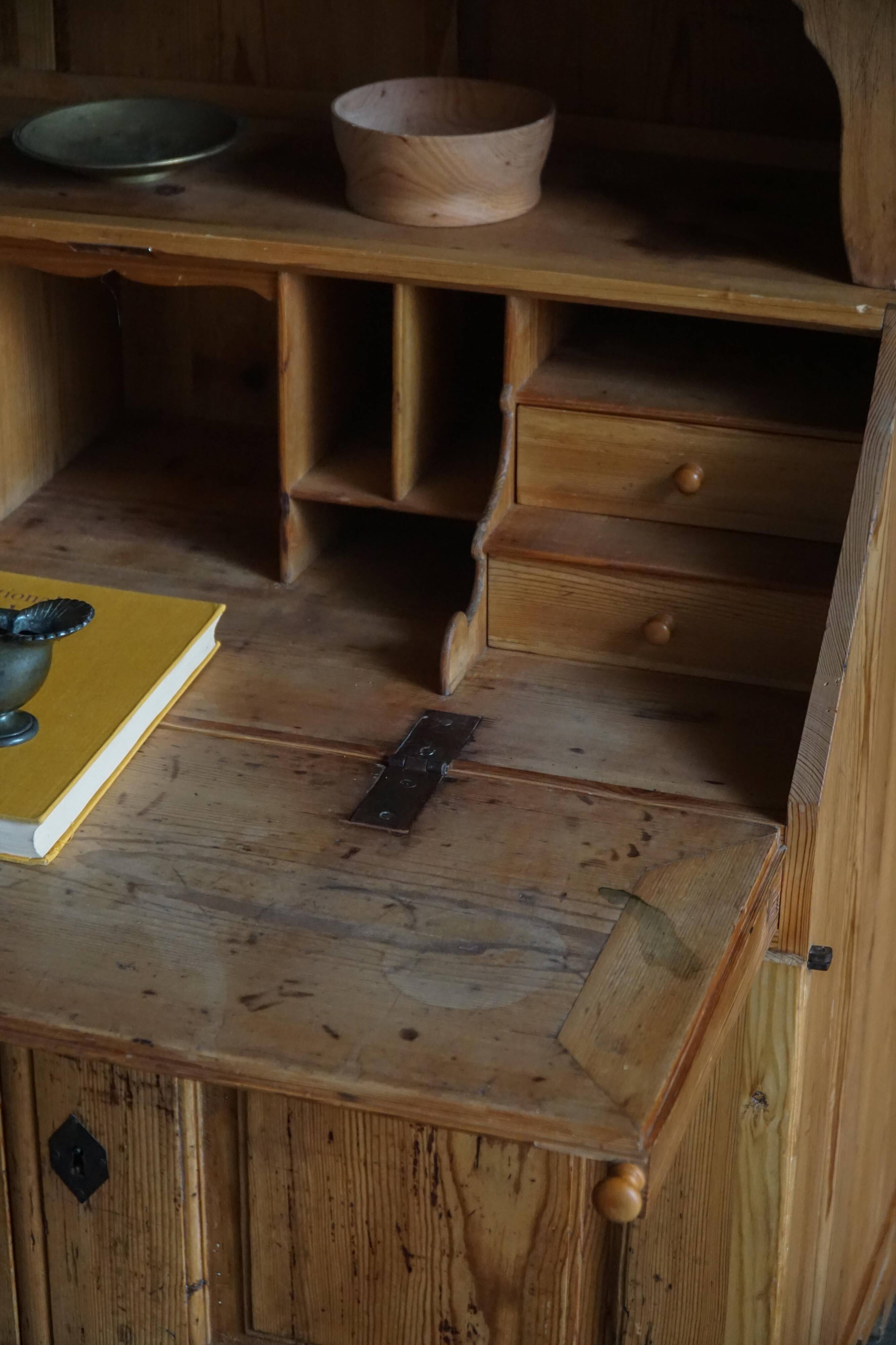 Old Danish secretary in pine with drop-down front and upper cabinet, mid-19th century.
