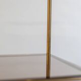 Free-standing shelf in gilded brass with smoked glass shelves. 1970s.