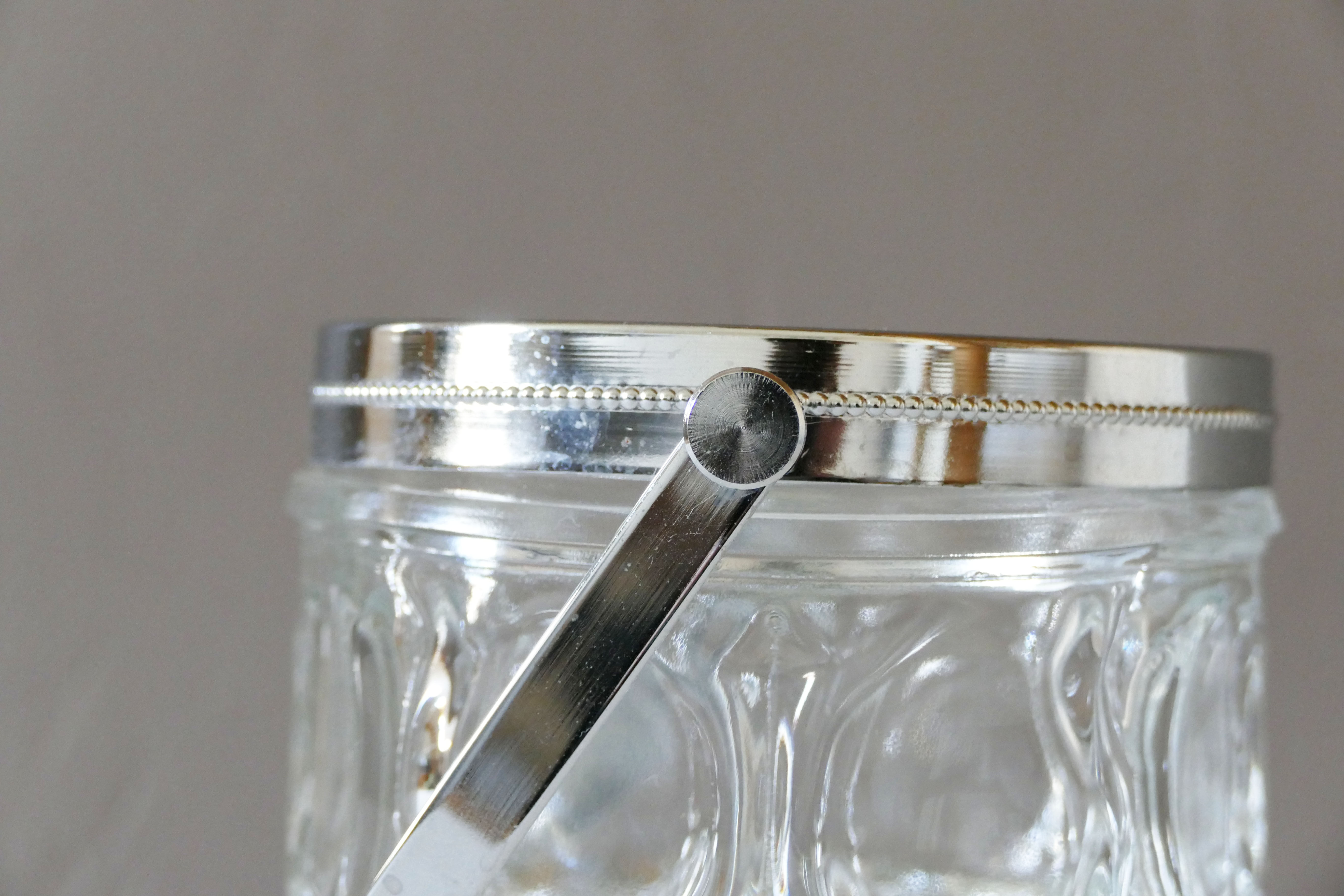 Vintage glass ice bucket stamped with a metal handle