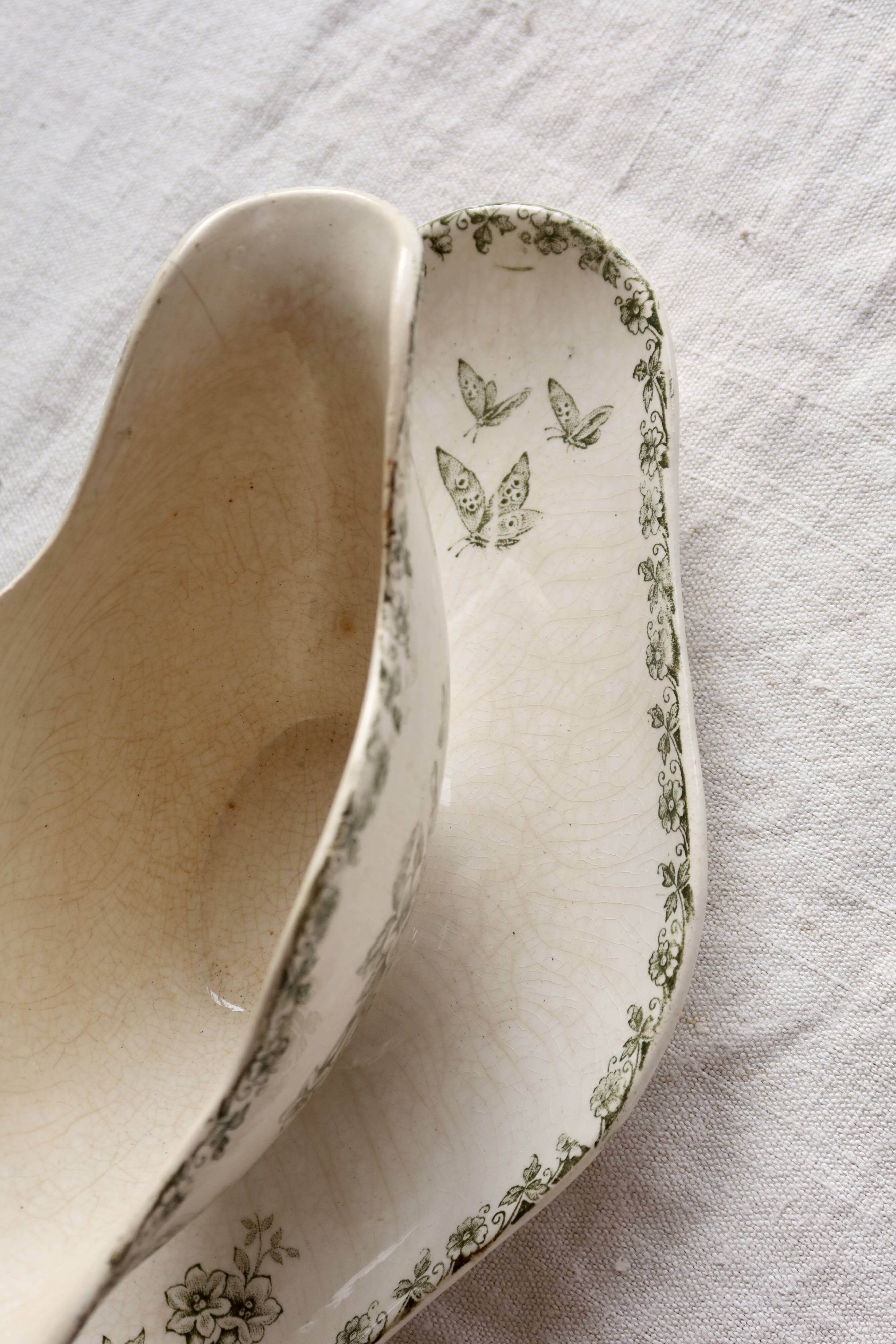 Antique sauce boat, ironstone, ivory with green floral and butterfly decoration.