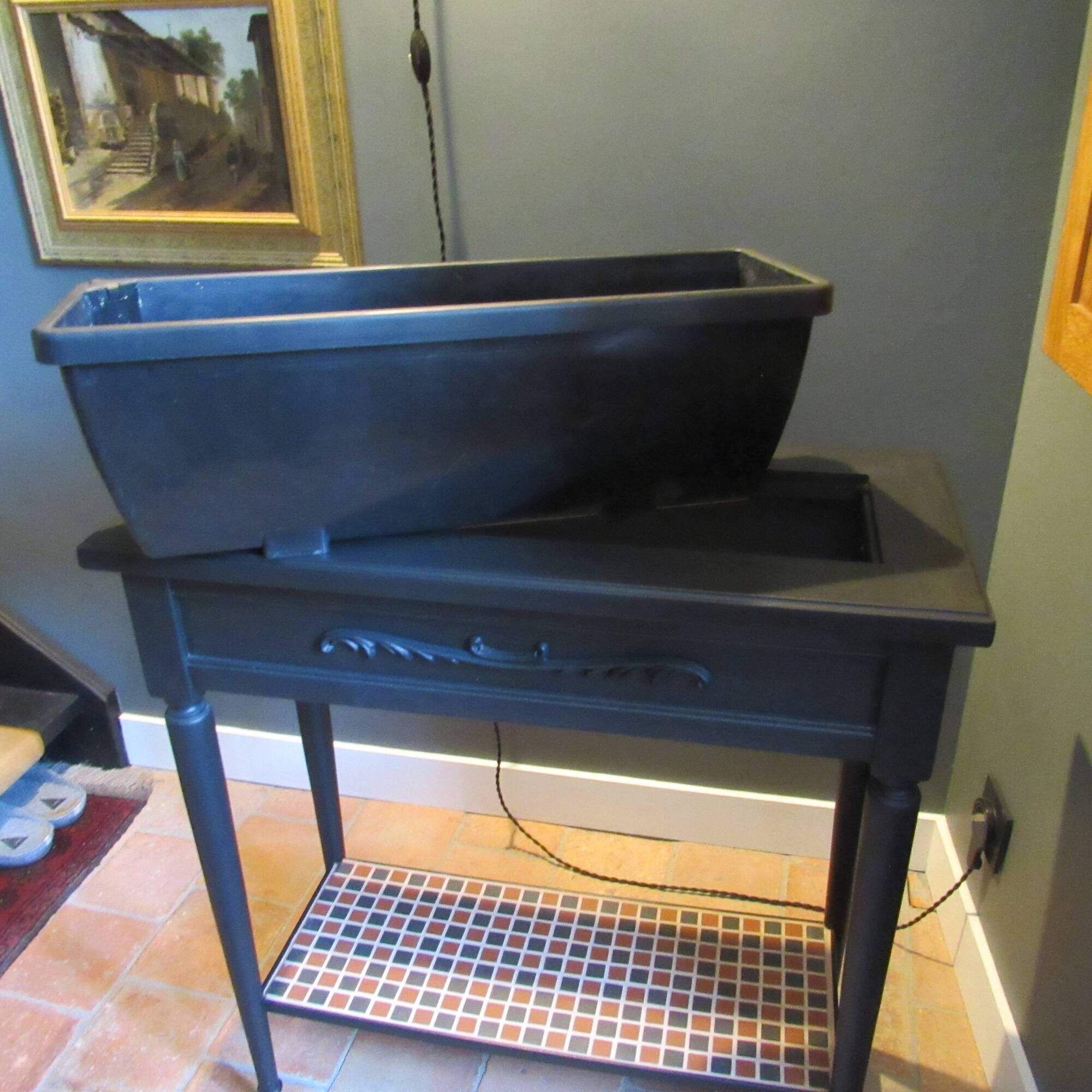 Vintage planter on wheels made of oak, repainted in black.