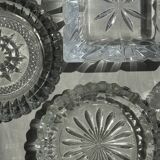 Circular glass ashtray with stylized petal patterns