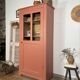 Antique glass-fronted terracotta cupboard