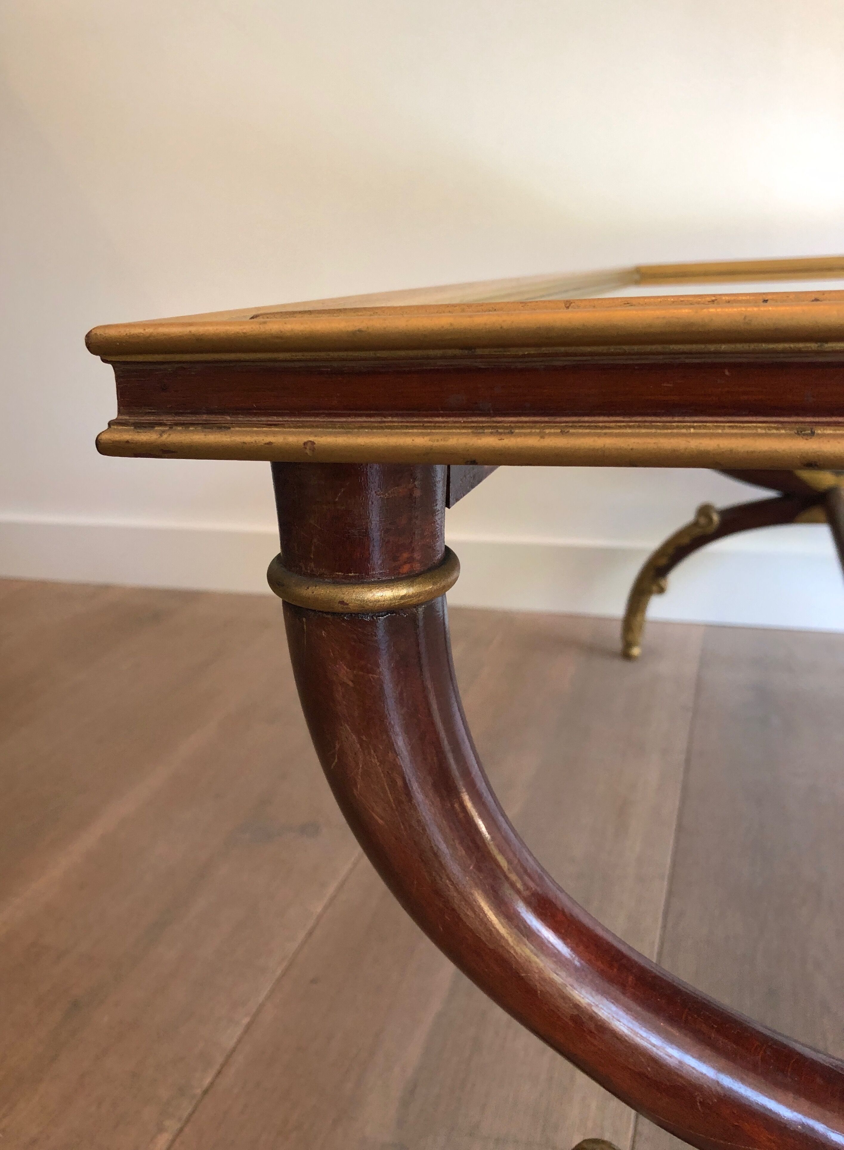 Coffee table in patinated and gilded carved wood with mirror top