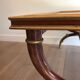Coffee table in patinated and gilded carved wood with mirror top