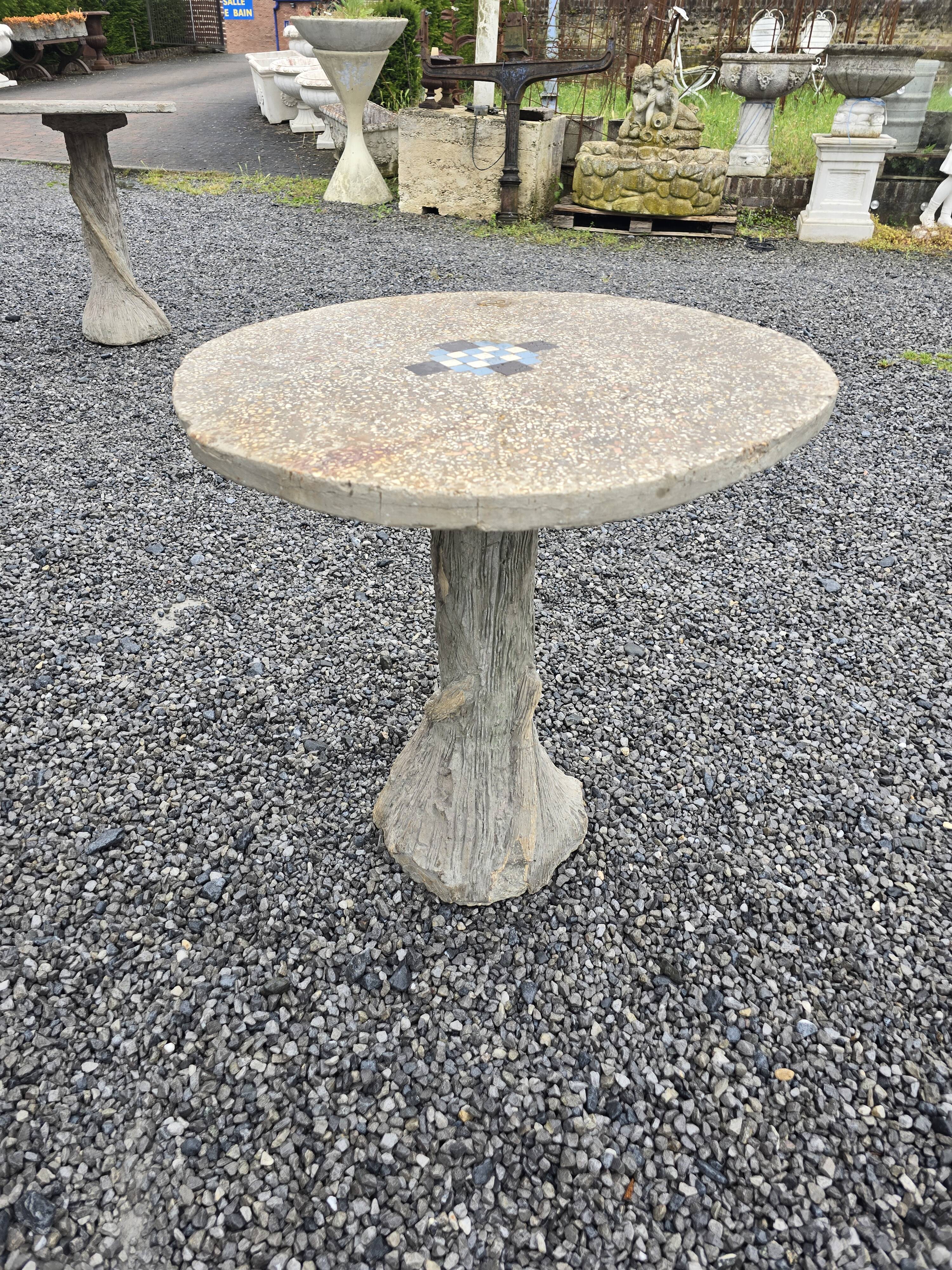 Cement garden table with trunk-shaped foot