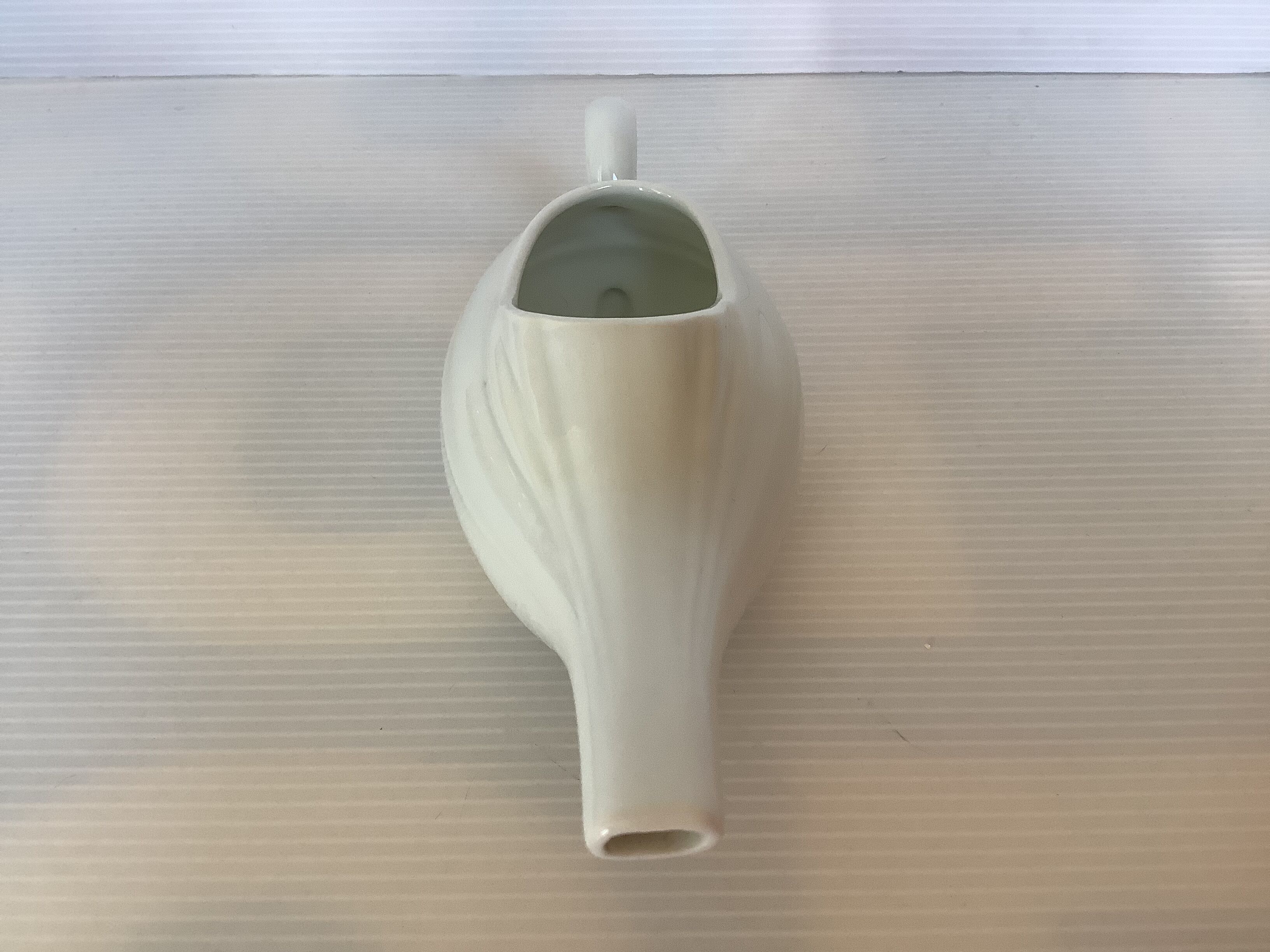 Old white porcelain baby bottle sauceboat