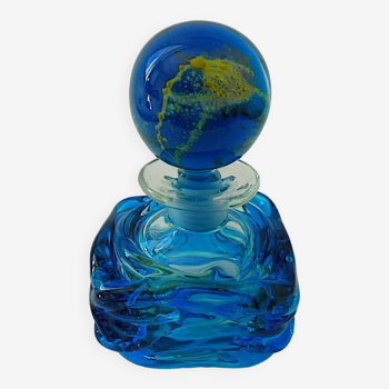 Blown blue glass bottle with inclusions