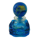 Blown blue glass bottle with inclusions