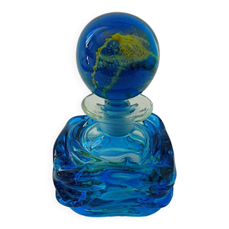 Blown blue glass bottle with inclusions
