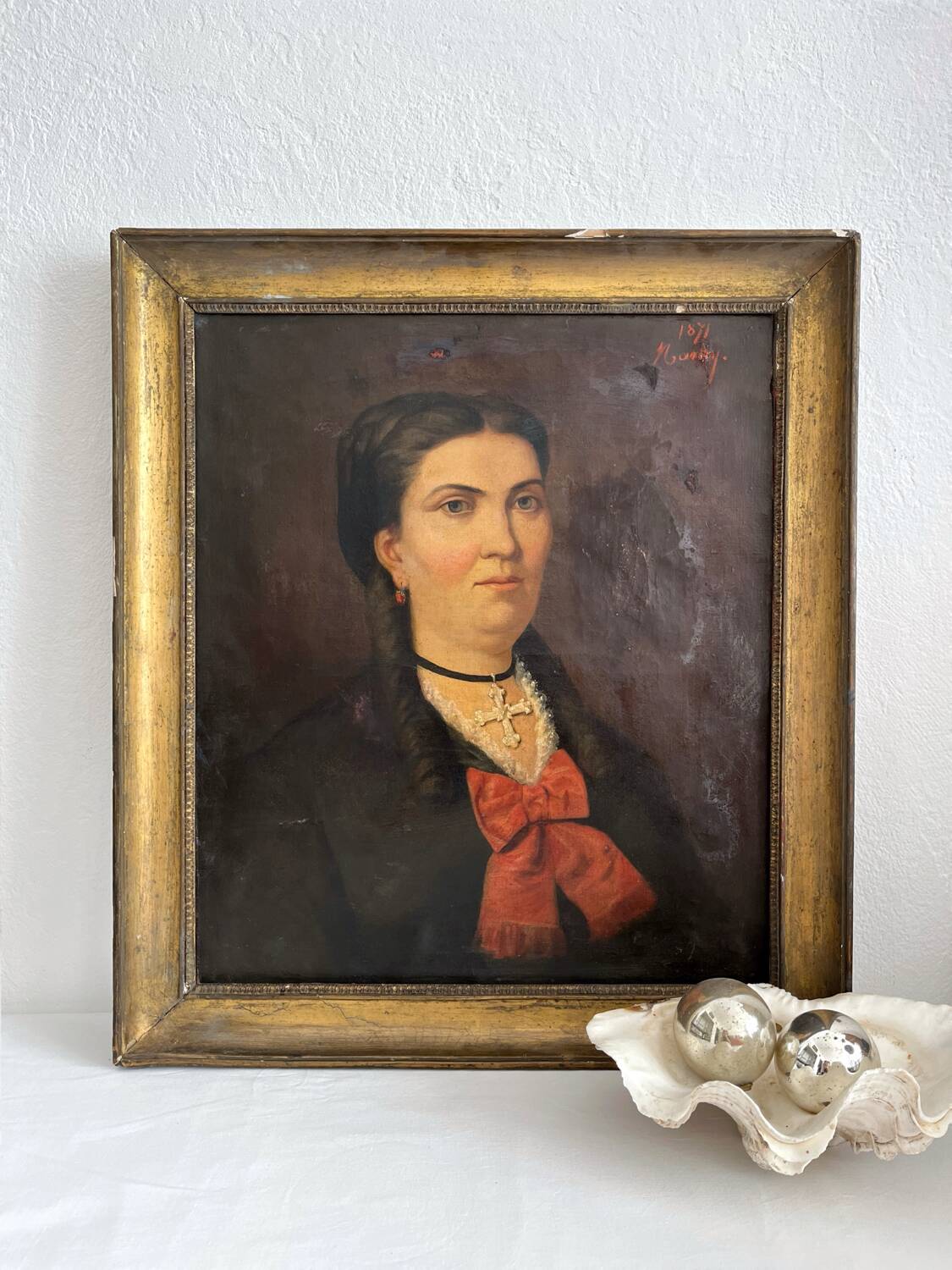 Old oil painting on canvas portrait of a woman with a red bow, late 19th century