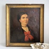 Old oil painting on canvas portrait of a woman with a red bow, late 19th century