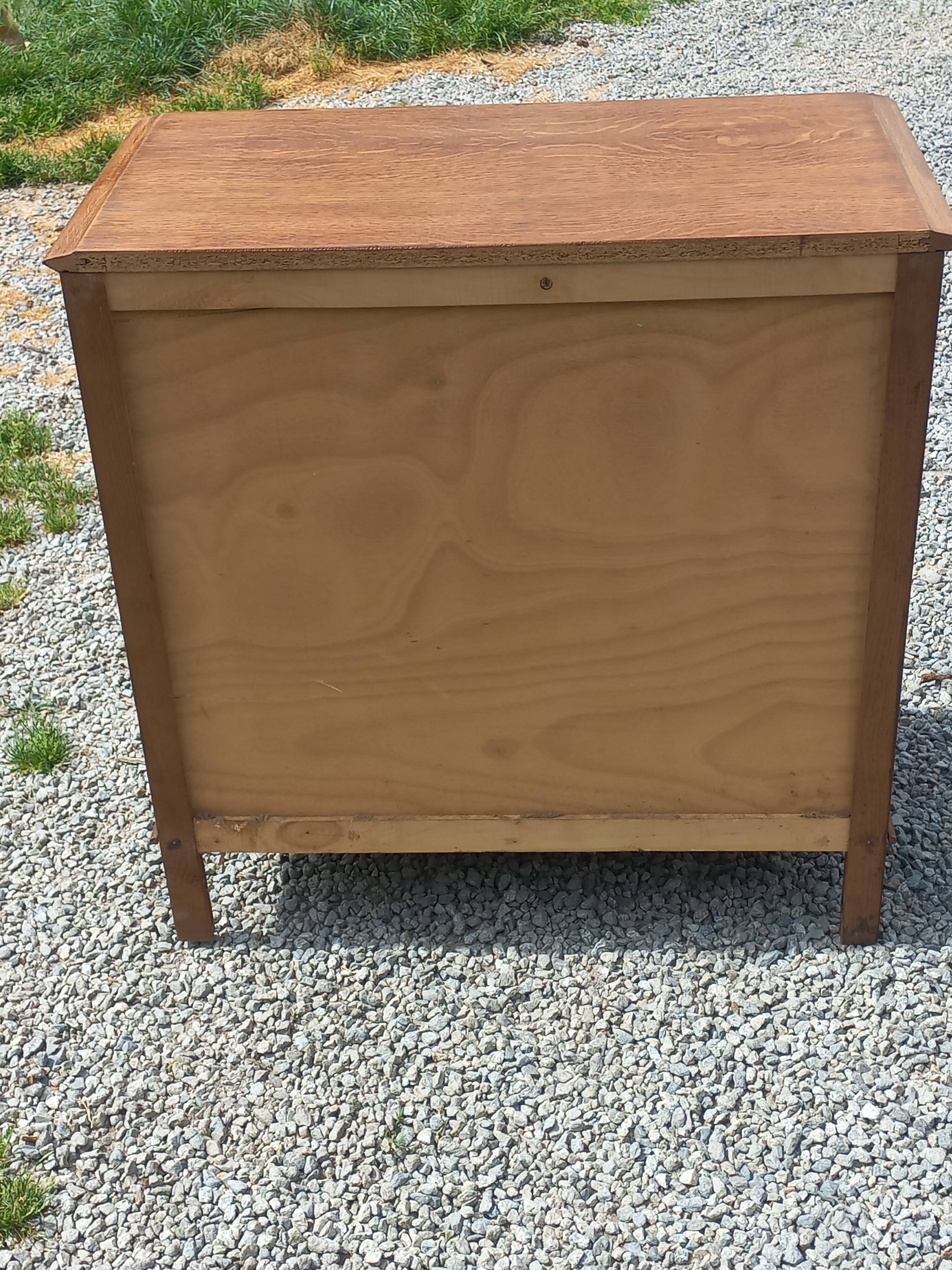 Vintage oak commode with tapered legs from the 1950s.