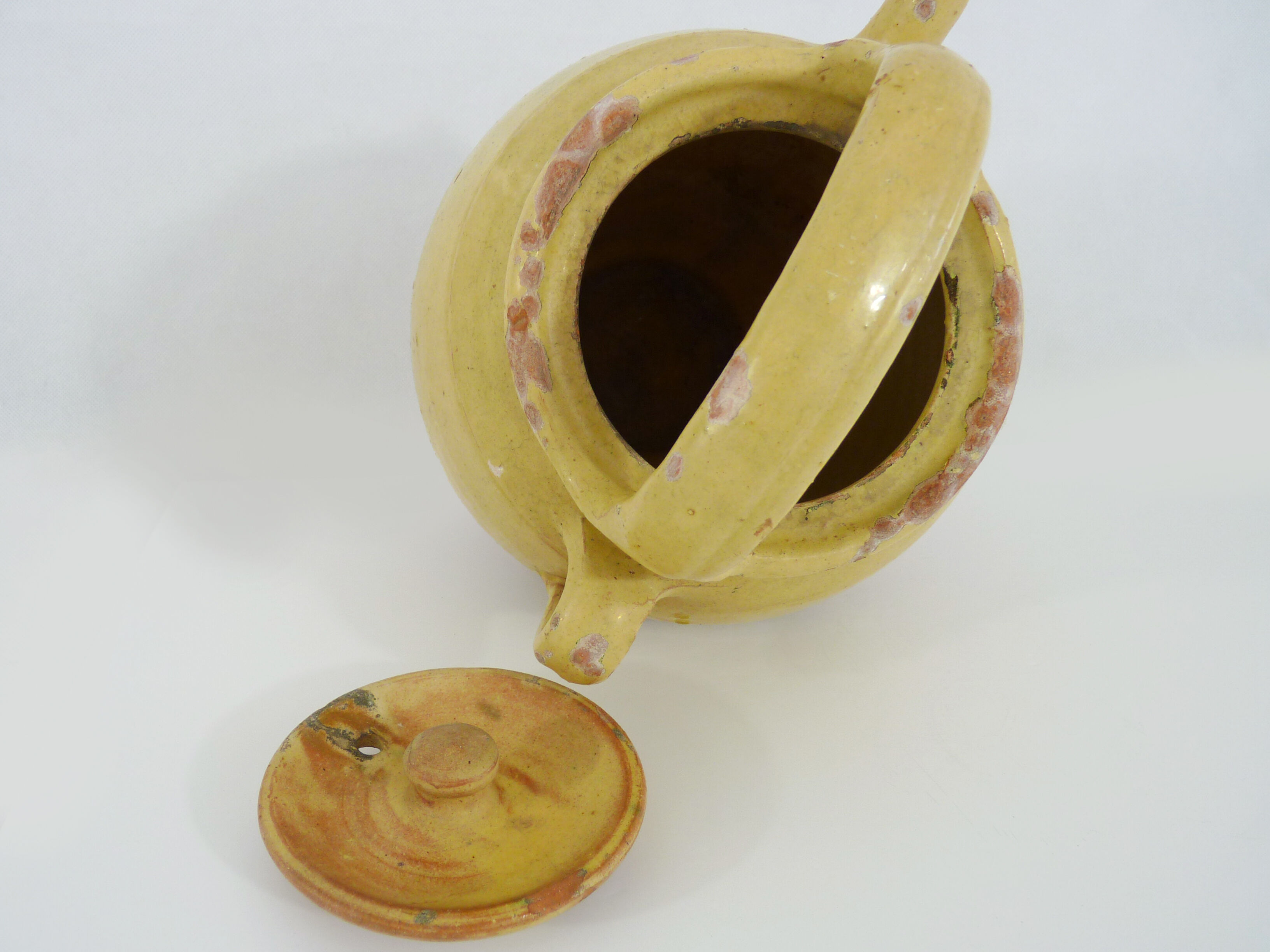 Old jug, chevrette, water pitcher in glazed yellow sandstone. Early twentieth century