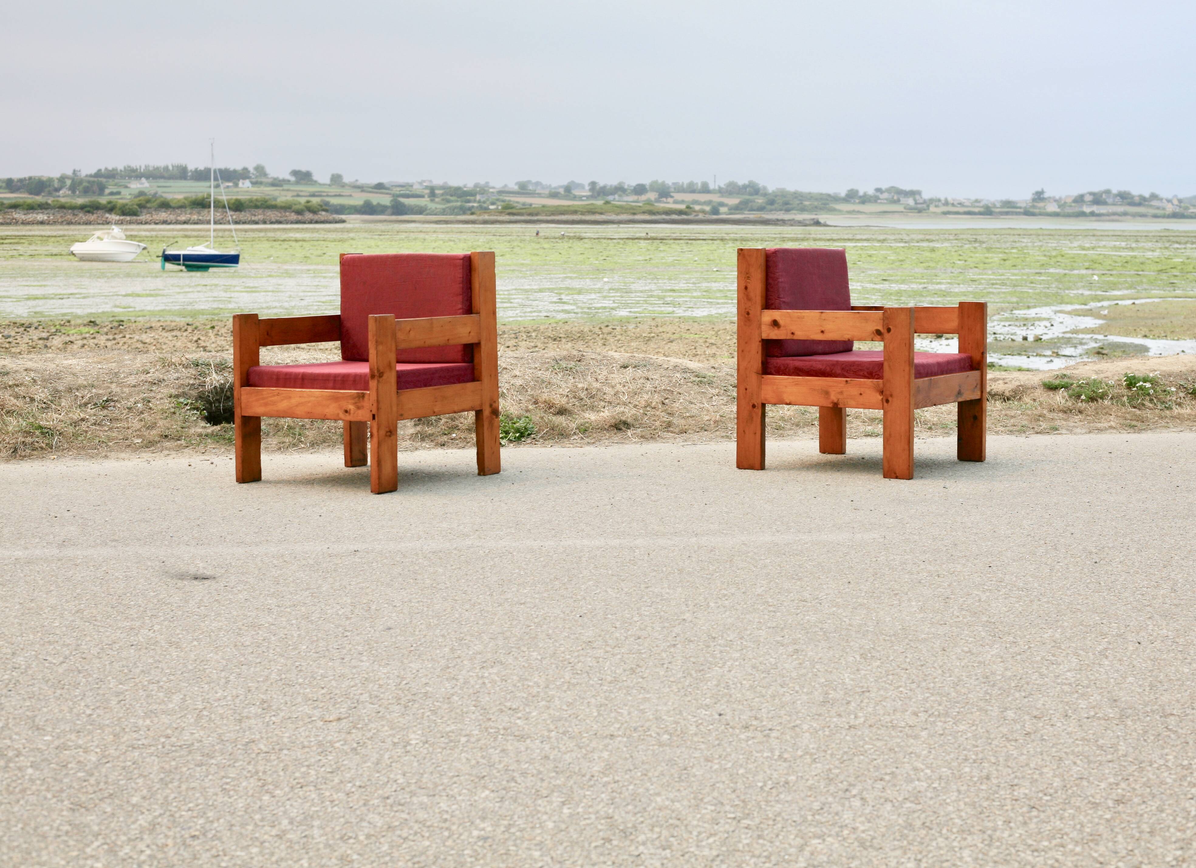 Pair of pine fireside chairs, France, 1960s, "raspberry" cushions