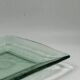Square sculptural glass plate, textured wavy finish.