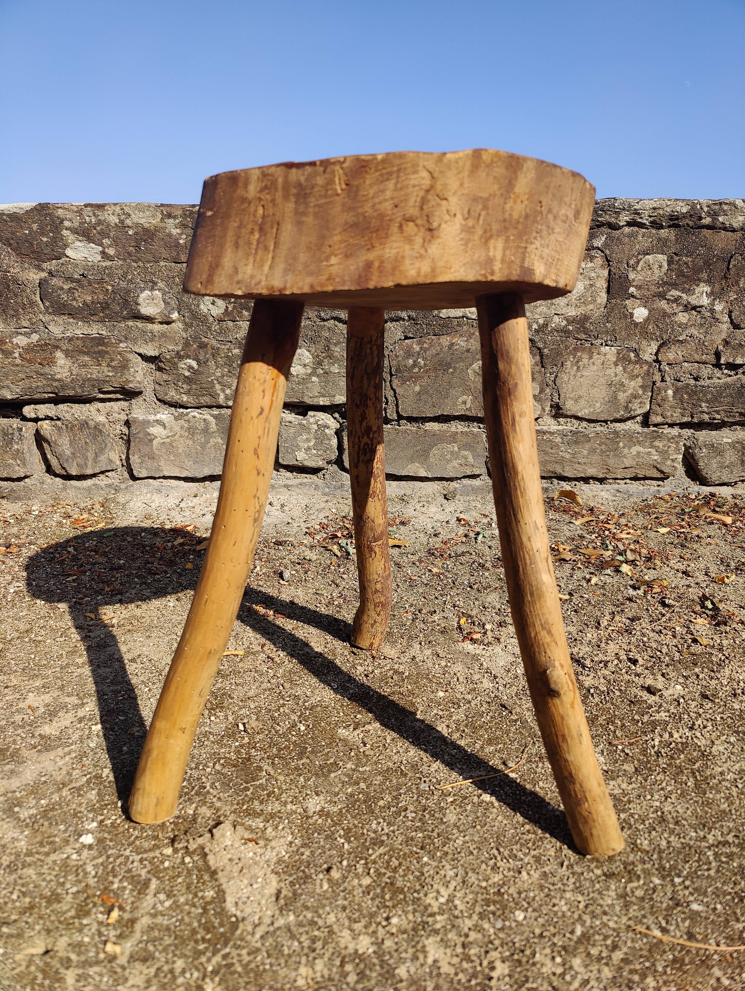 Rustic three-legged stool in minimalist wood in the style of Touret.