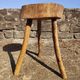 Rustic three-legged stool in minimalist wood in the style of Touret.