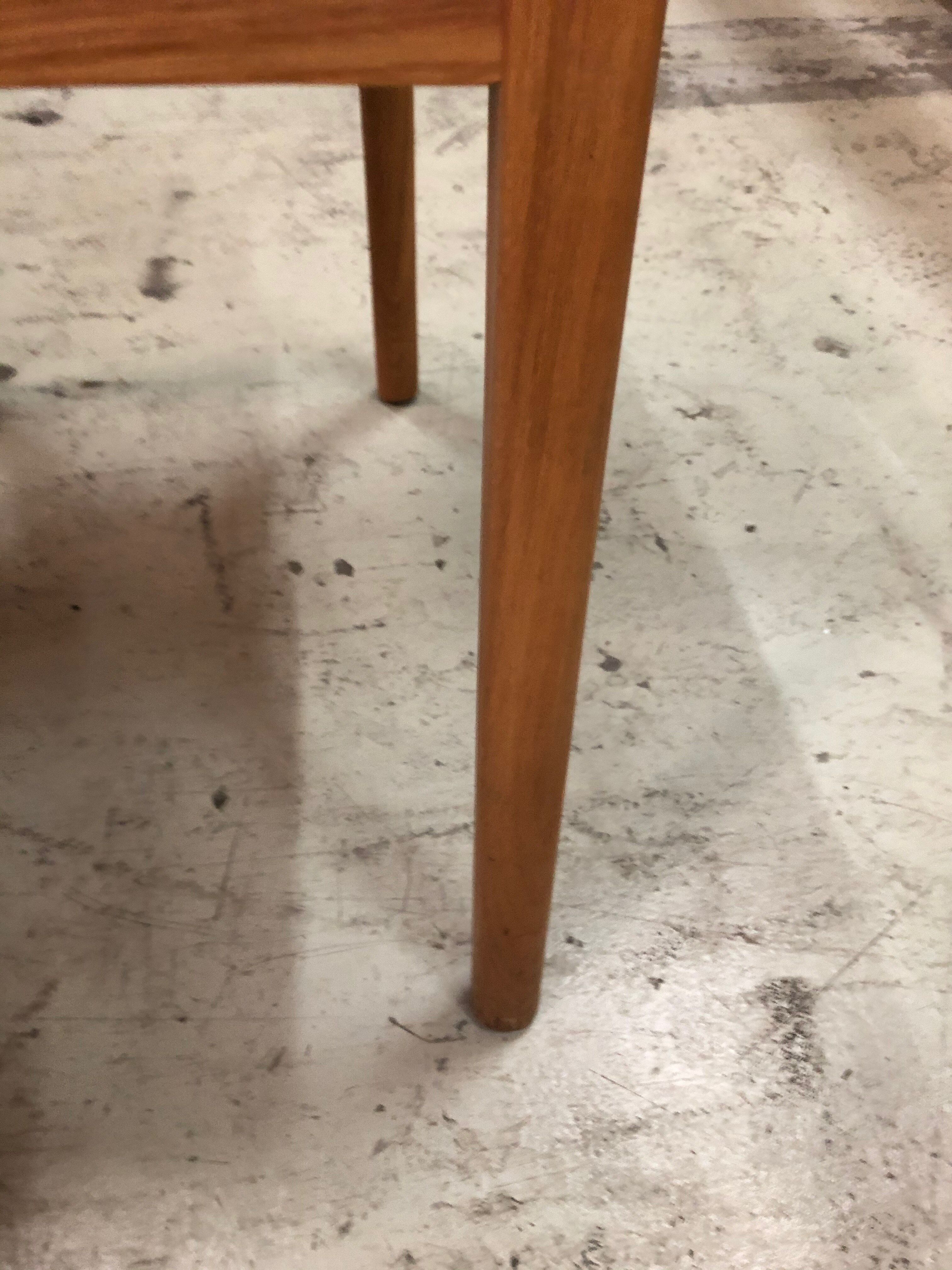 Light wood caning chair with black leather armrests