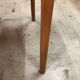 Light wood caning chair with black leather armrests