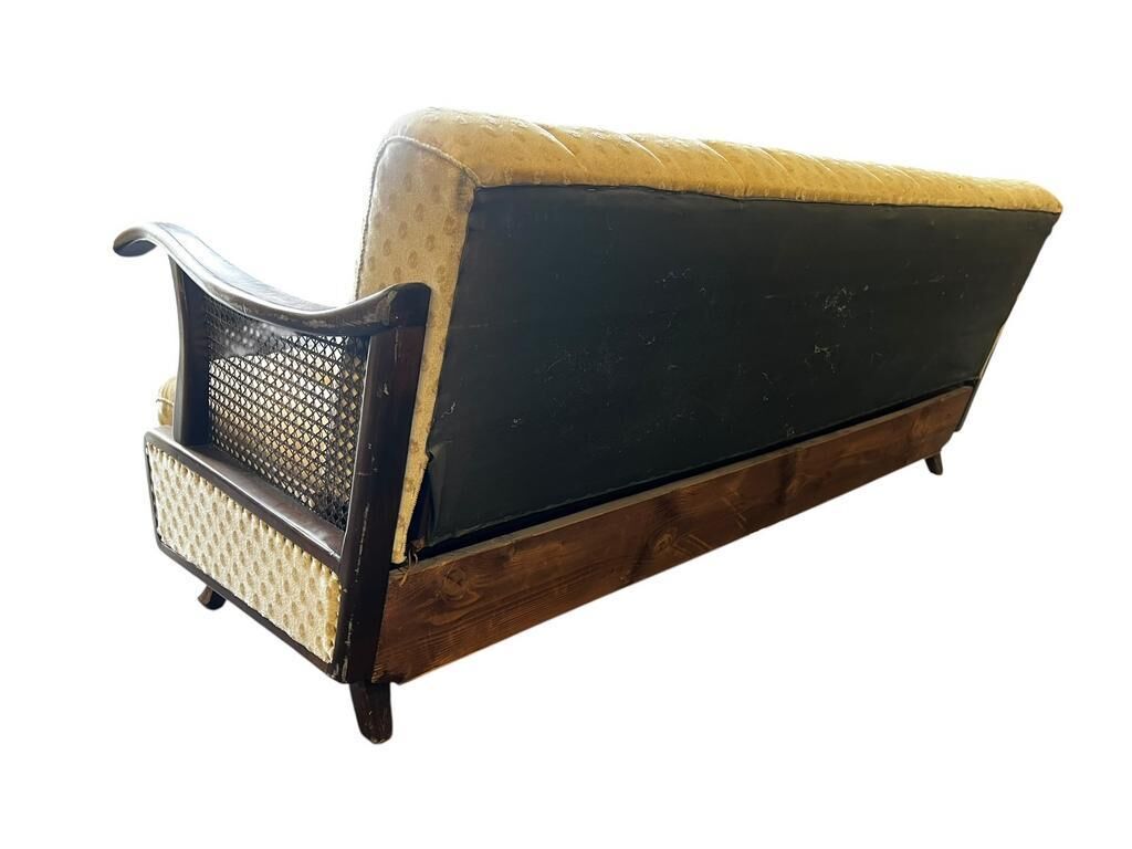 Vintage wooden armchair with rattan weaving.