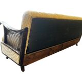 Vintage wooden armchair with rattan weaving.