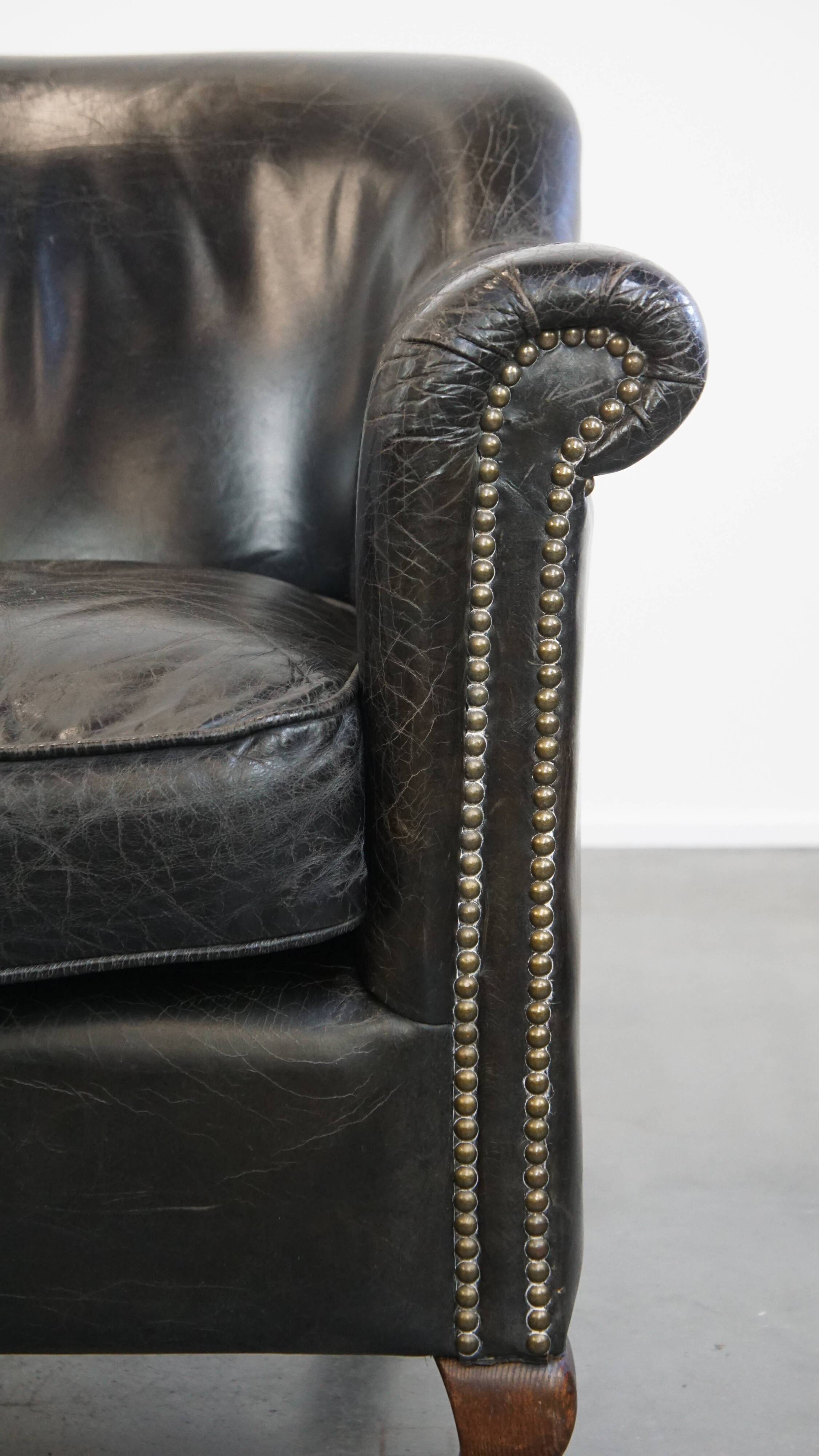 Black grained cowhide leather armchair