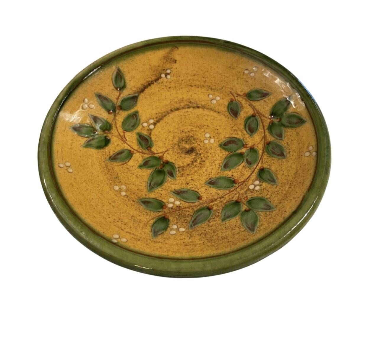 Decorative glazed terracotta plate with olive leaf pattern.