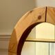 Round mirror in raw wood