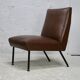 Low chair, circa 1950. Brown imitation leather.