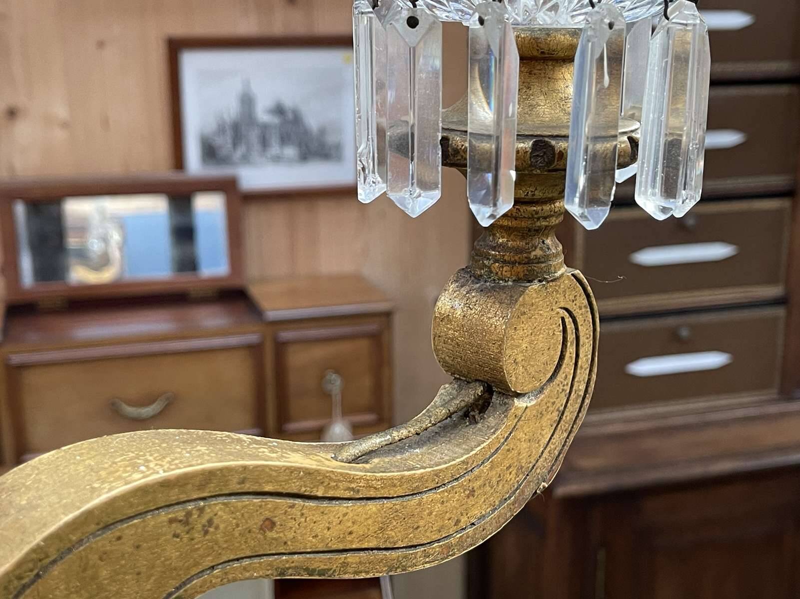 Golden wooden chandelier with crystal pendants from the 19th century.