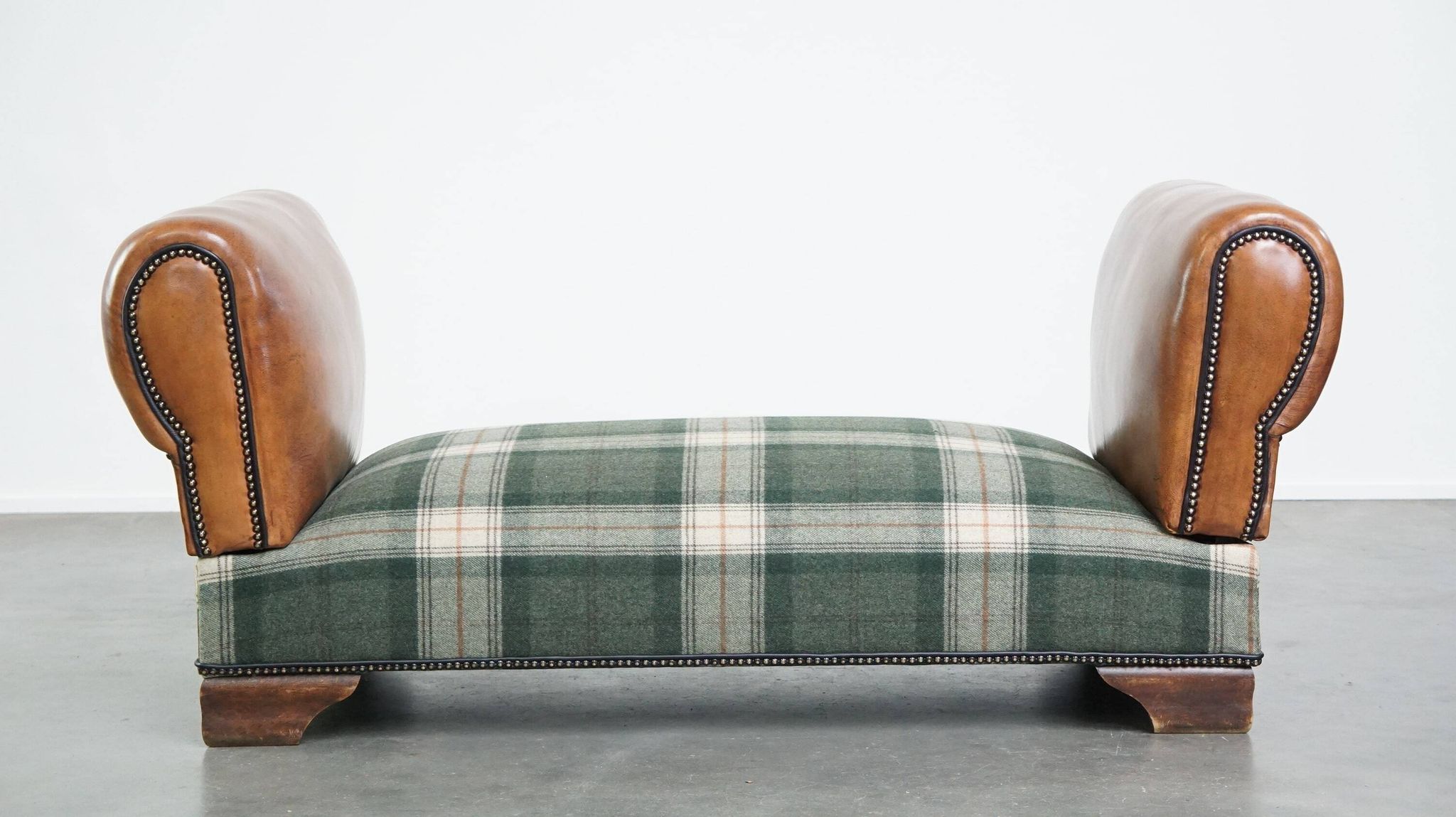 Antique daybed reupholstered with sheepskin and Scottish tartan wool
