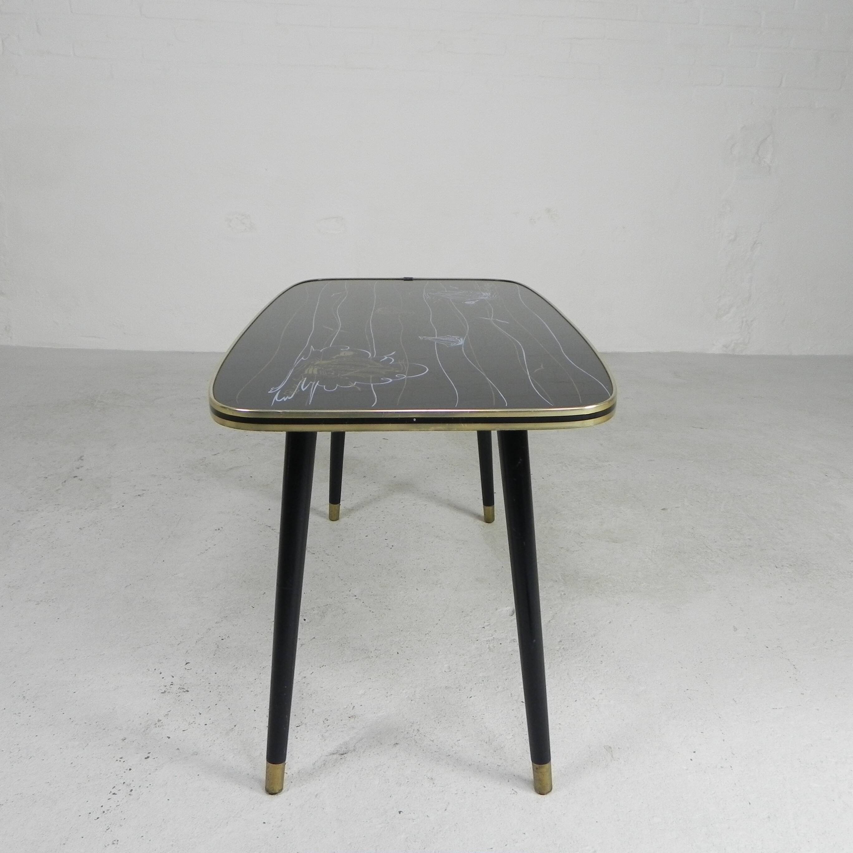 Vintage coffee table with glass top and angled legs