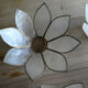 Brass chandelier and flowers in mother-of-pearl petals