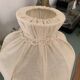 Small vintage wooden turned table lamp with a pleated shade.