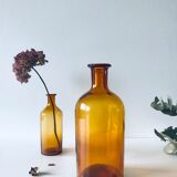 Duo of ancient apothecary flakes in amber glass