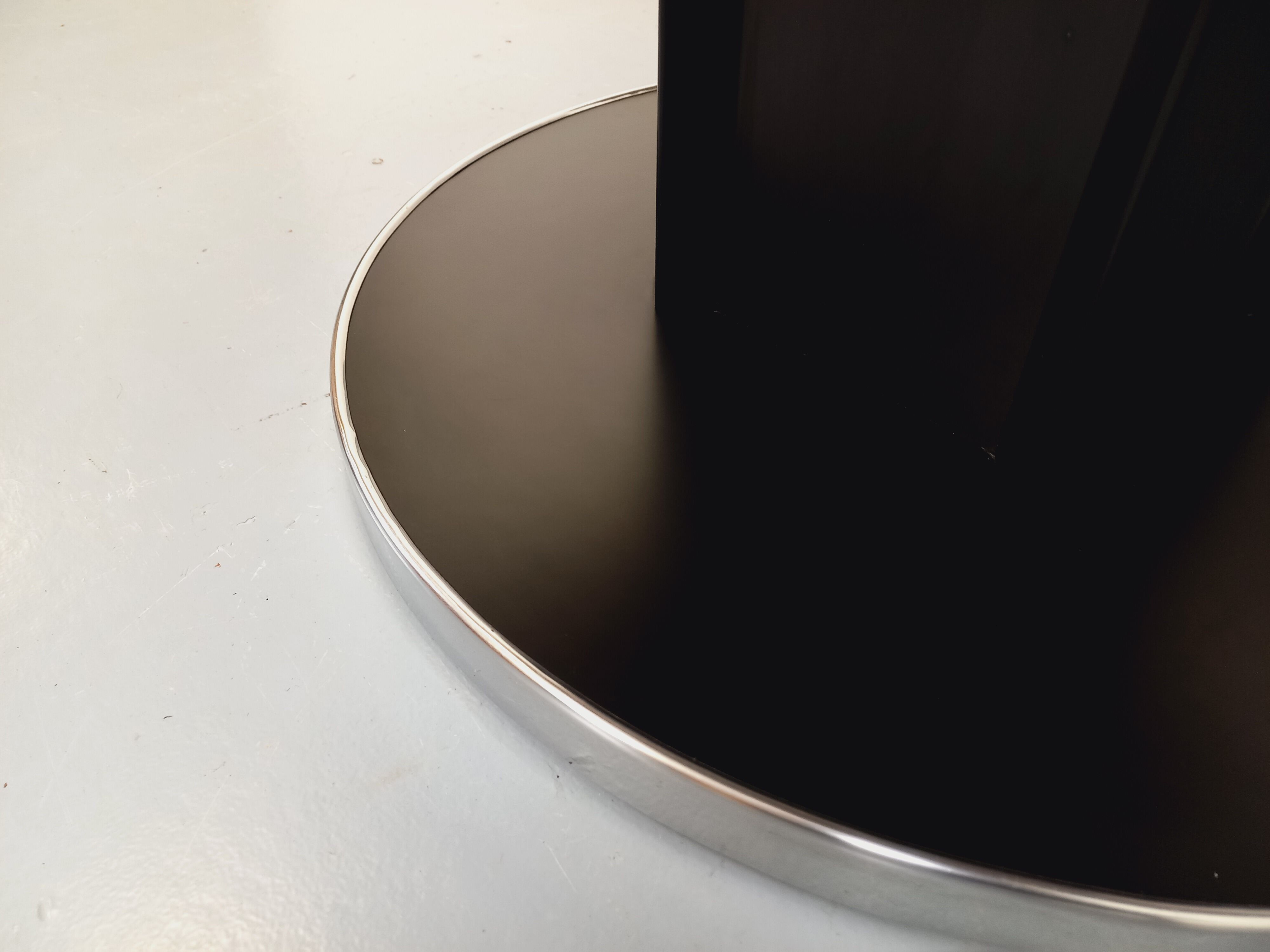 Vintage dining table in melamine with a black wood effect and chrome metal.