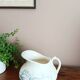 Old bulbous jug in ironstone earthenware