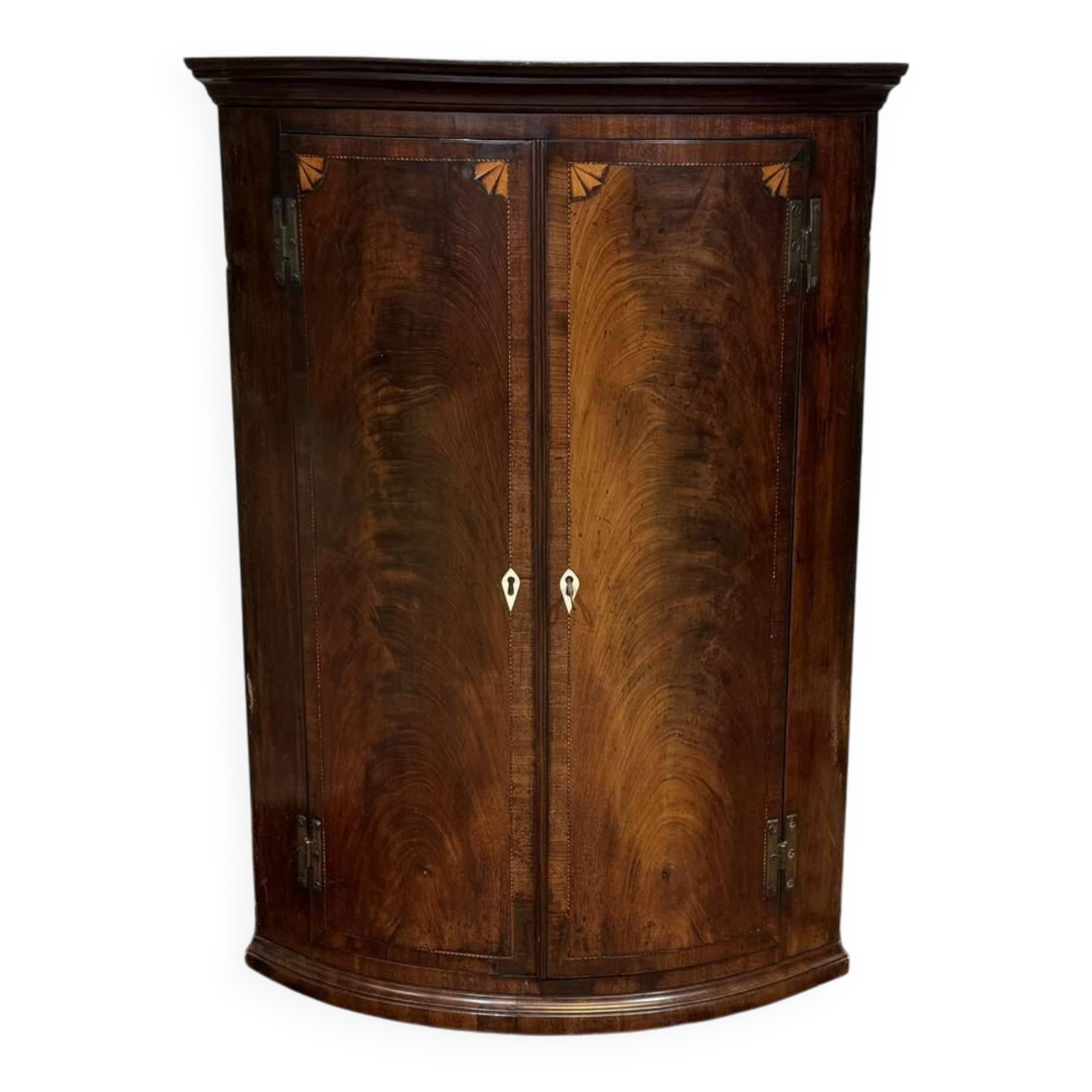 19th-century curved English mahogany corner cabinet.