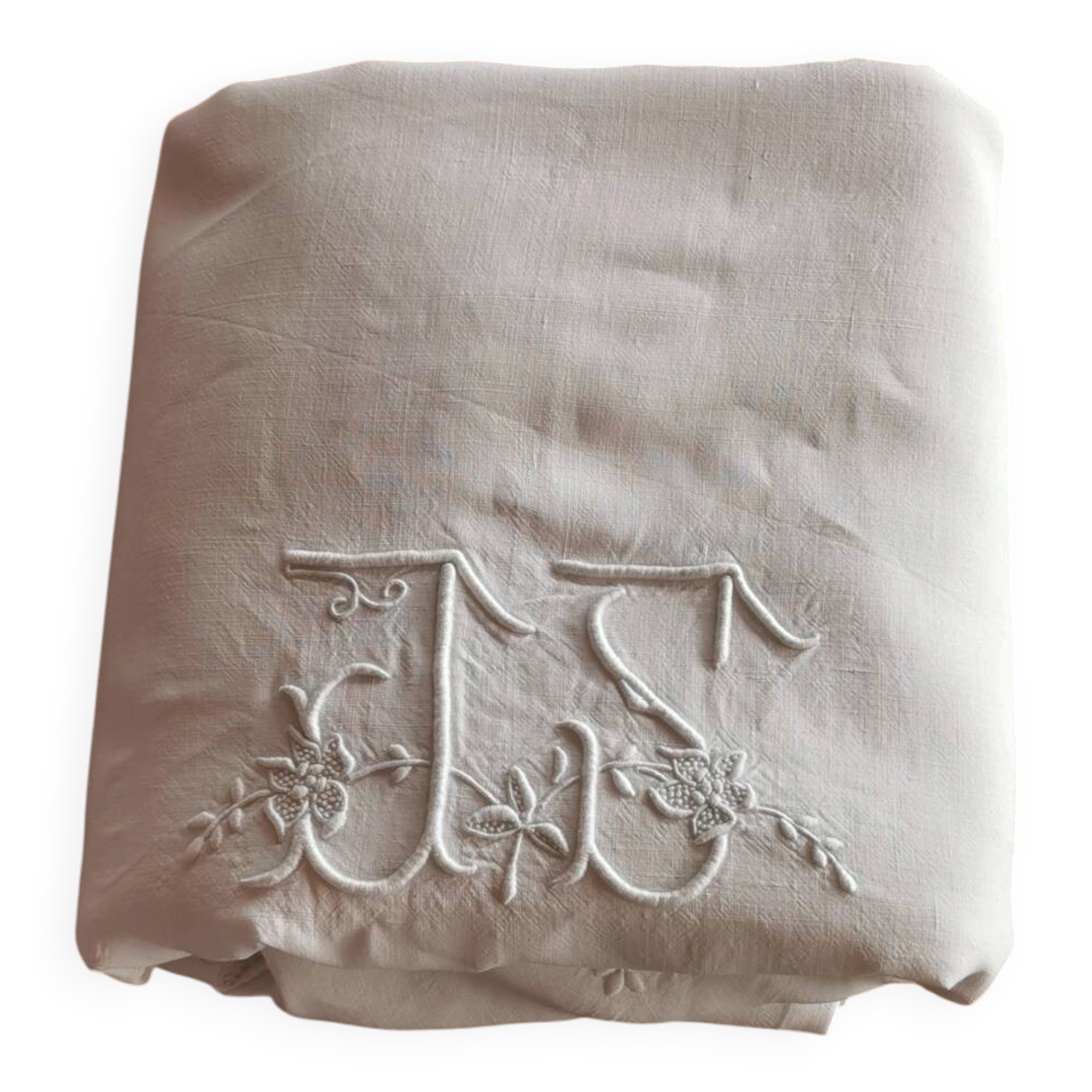 Antique embroidered linen sheet with a monogram.