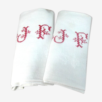 A pair of white cotton towels with red monogram
