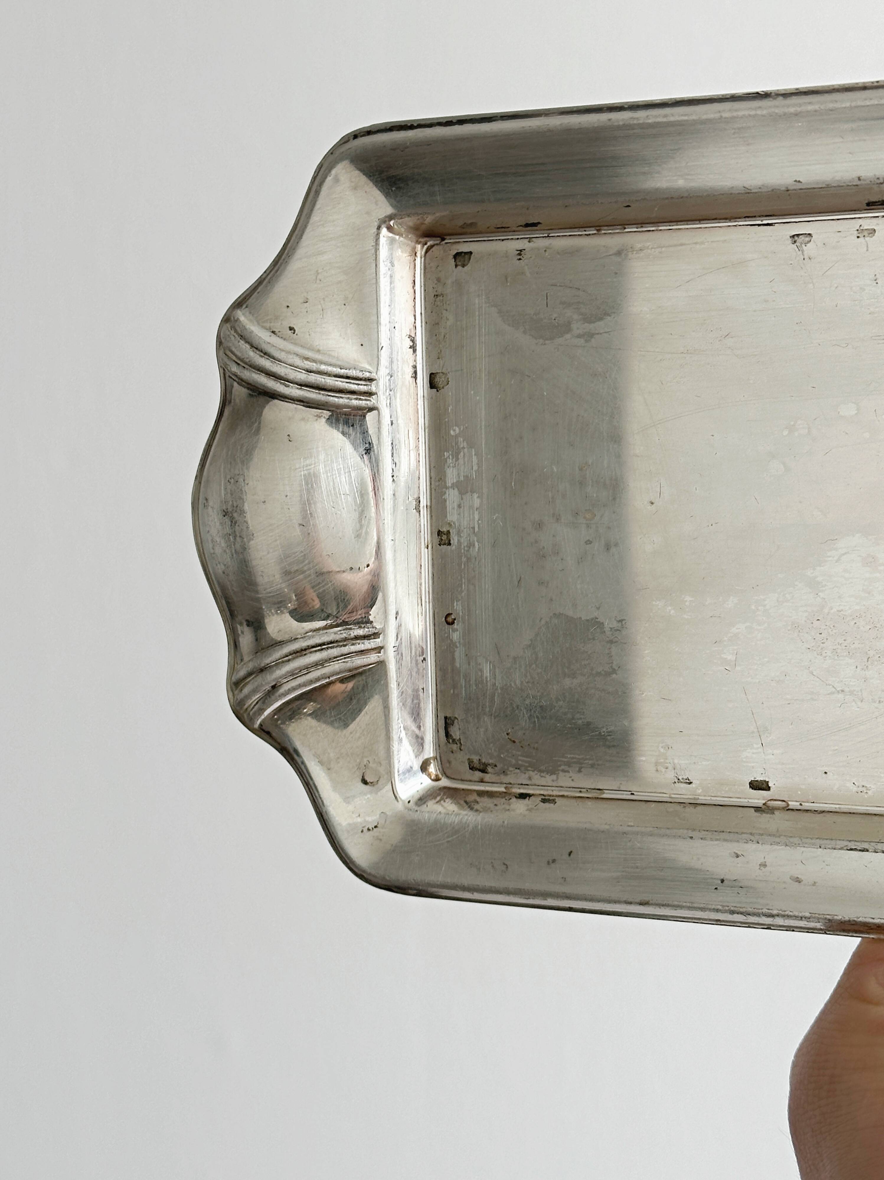 Metal butter dish and thick rectangular glass bowl.