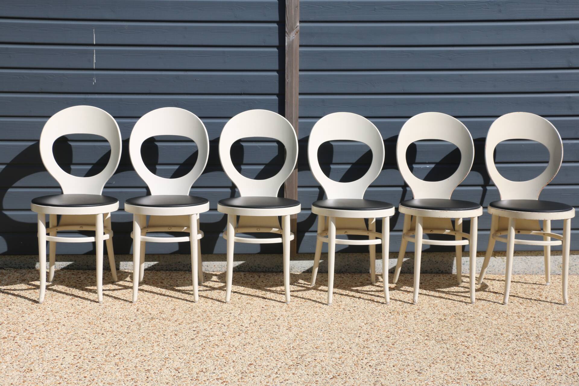 6 baumann chairs, white gull with black faux leather.