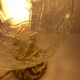Small handcrafted globe lamp with a cracked finish and a golden brass base.