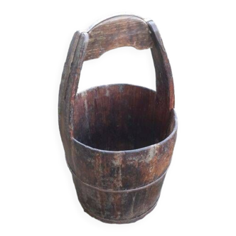 Old well bucket in rimmed wood