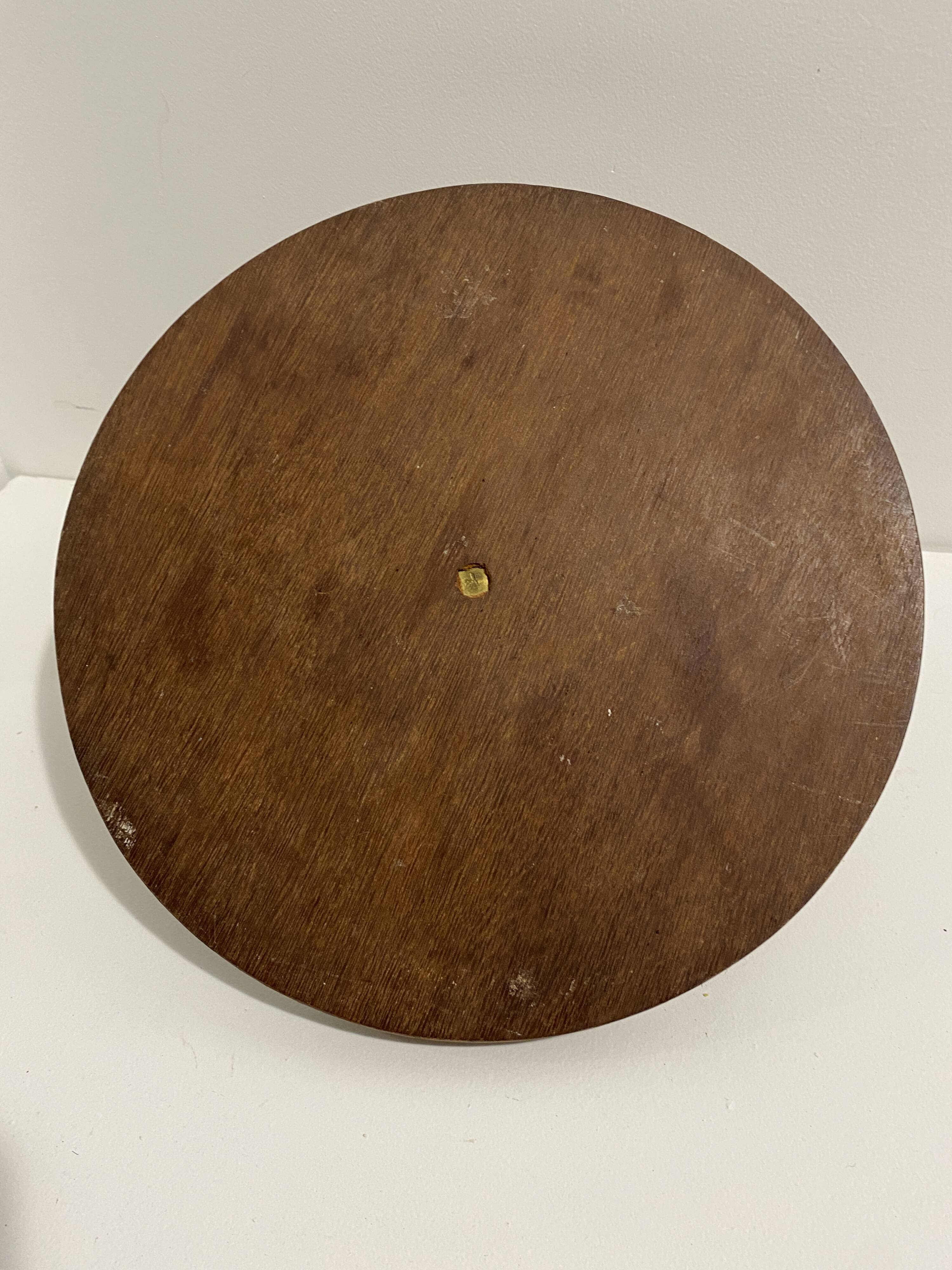Vintage round wooden cheese board covered with glass plate with foldable handle