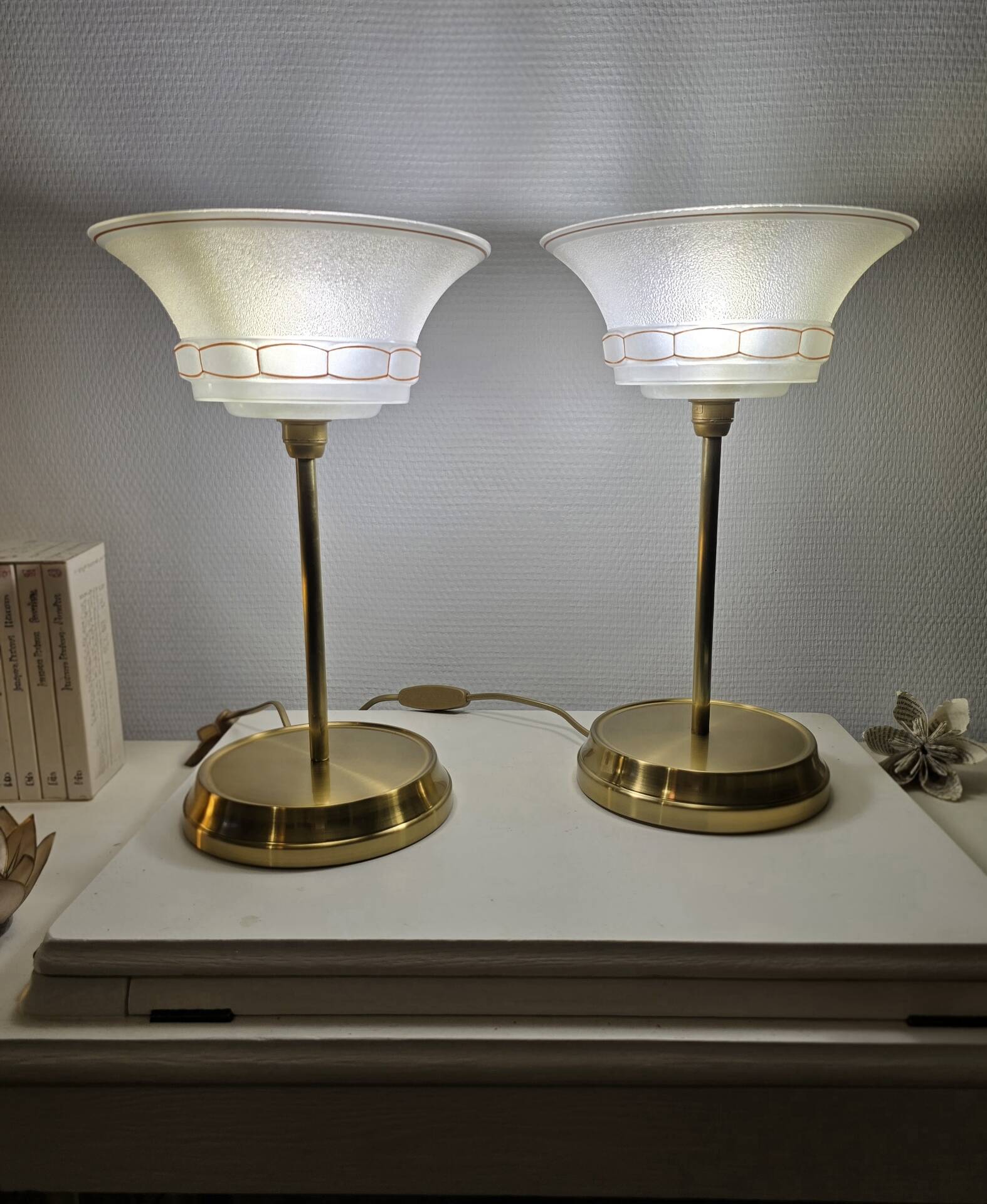Art Deco table lamps with frosted glass shade and brass base.
